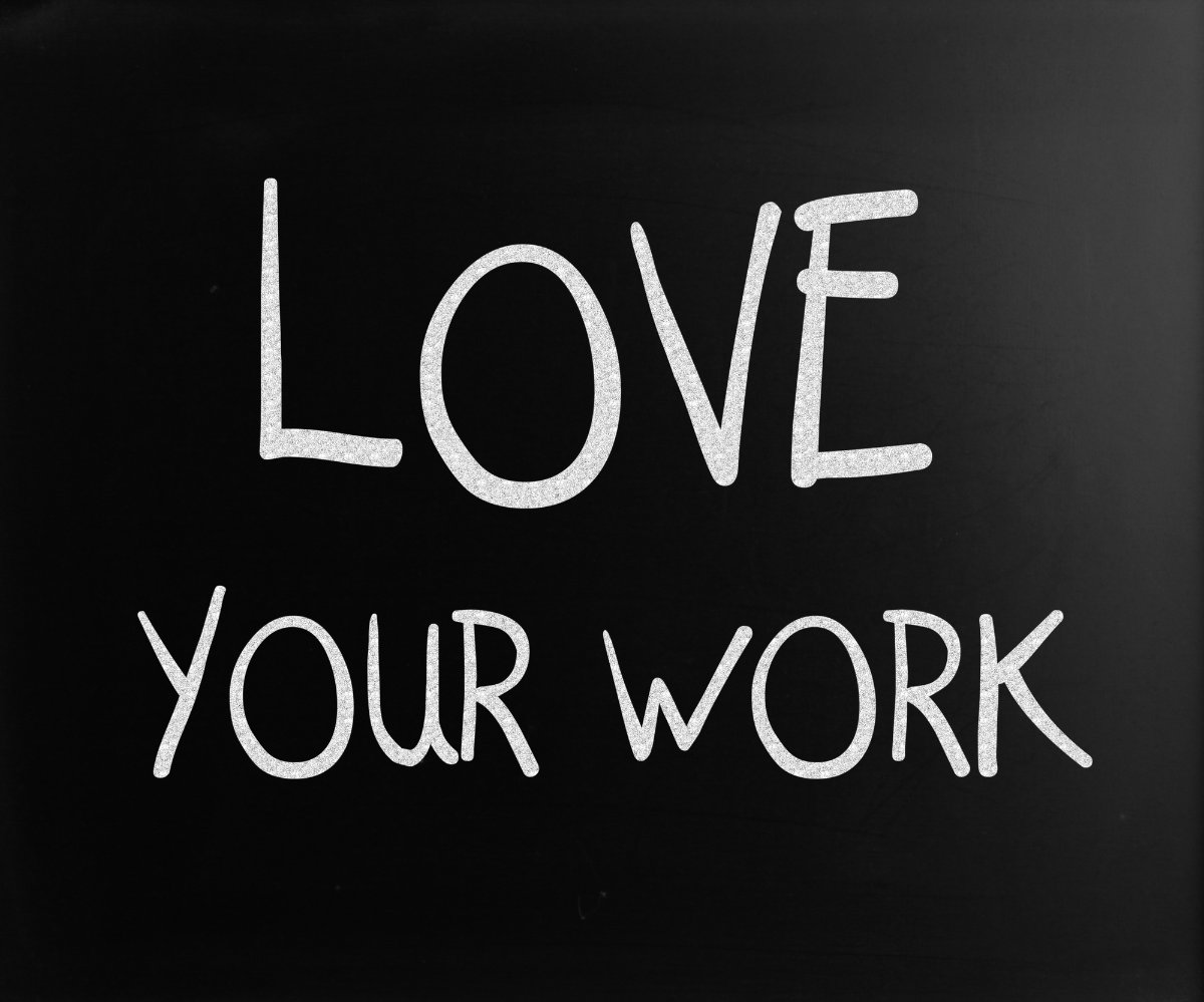 "Love your work" handwritten with white chalk on a blackboard.